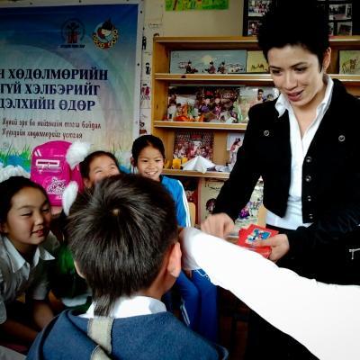 Teaching volunteer in Mongolia uses a game to teach English words. The children play a word game with the volunteer teaching English in Mongolia.